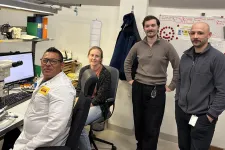Four engineers in front of a microscope. From the left: Jorge Canales, Emelie Haettner, Julius Modin, Alexander Graves